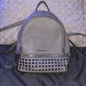 Micheal Kor’s rhea zip pyramid stud backpack
